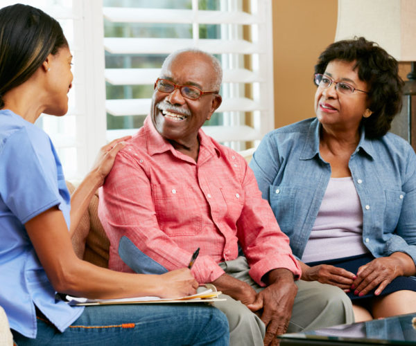 Couple talking with a lady in scrubs